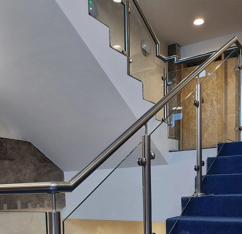 Partial glass balustrade with stainless steel handrail for an office staircase