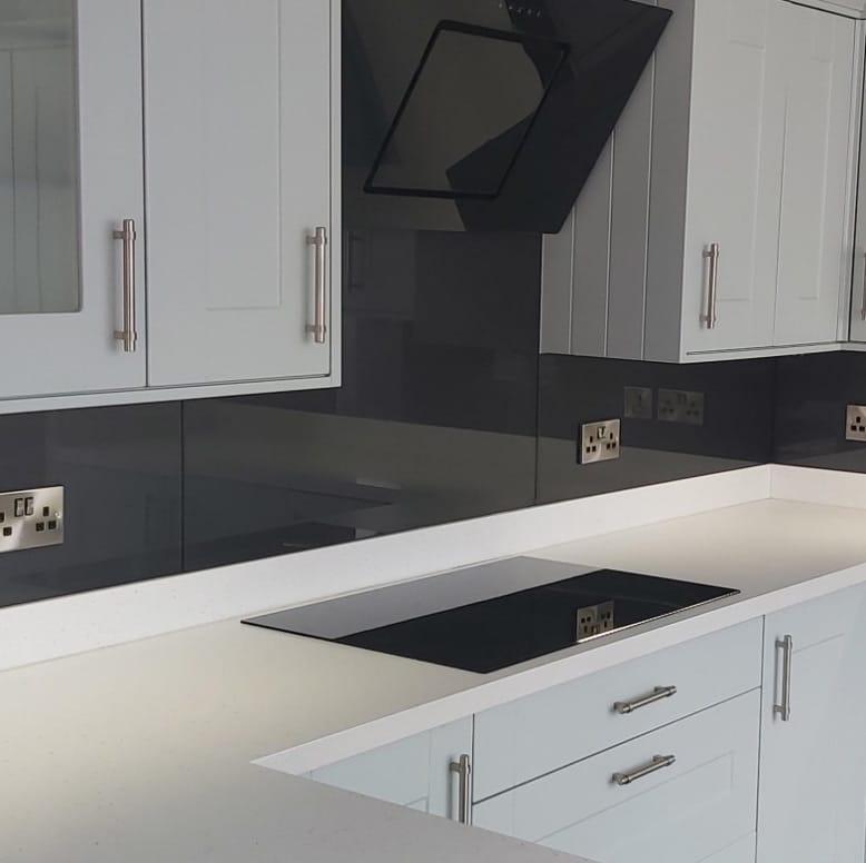 Black glass splashback above kitchen countertop