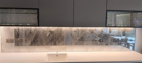 Antique mirror above kitchen countertop