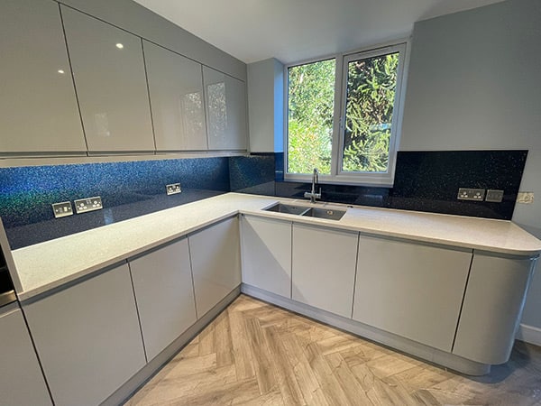 Rainbow blue hued sparkle glass splashback above kitchen countertop