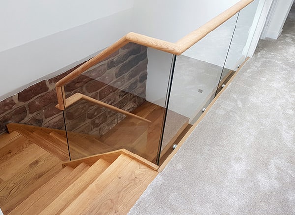 Glass balustrade with wooden banister