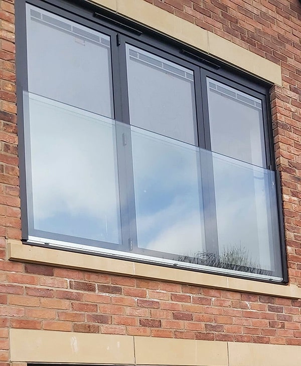 Frameless Juliet balcony across three windows