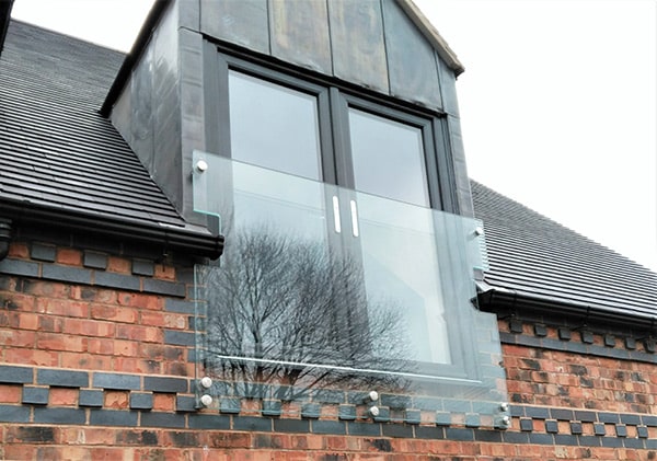Frameless Juliet balcony across dormer double doors