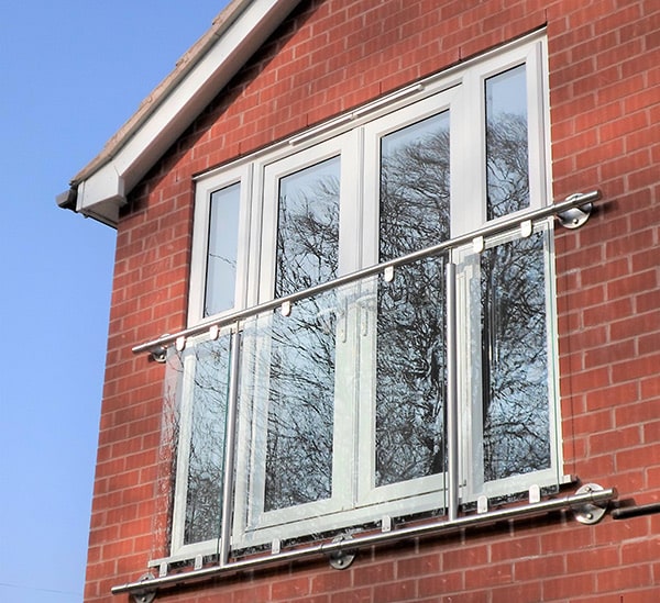 Juliet balcony with stainless steel banister across upper floor doors