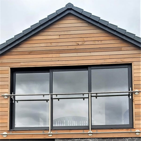 Juliet balcony with stainless steel banister across three windows