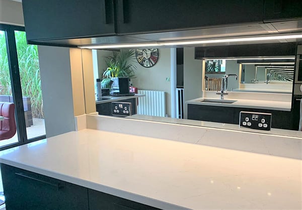 Splashback mirror above kitchen countertop