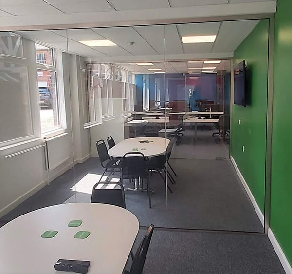 Floor to ceiling glass partition in an office