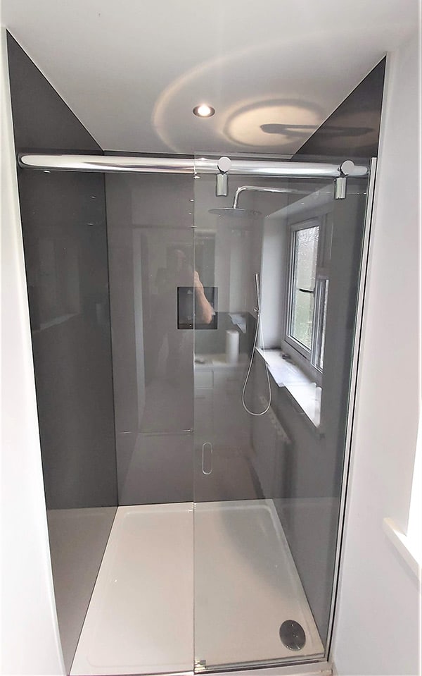 Glass sliding shower screen with stainless steel rail