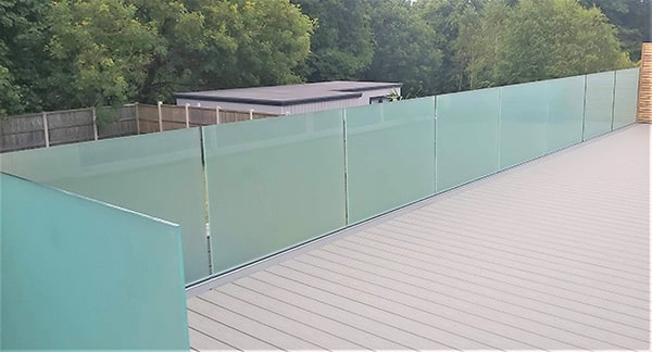 Frameless frosted glass balustrade around decking