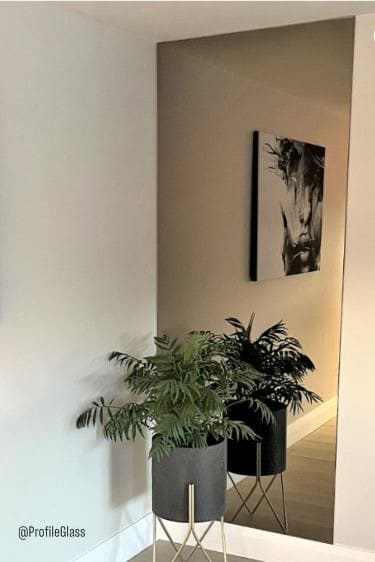 Floor to ceiling custom cut mirror with bronze tint