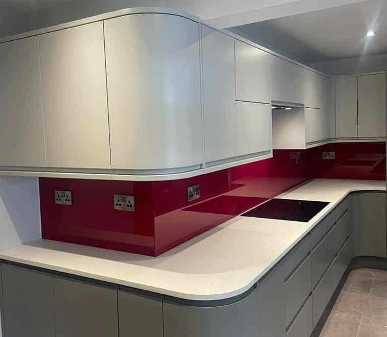 red coloured glass splashback over countertop