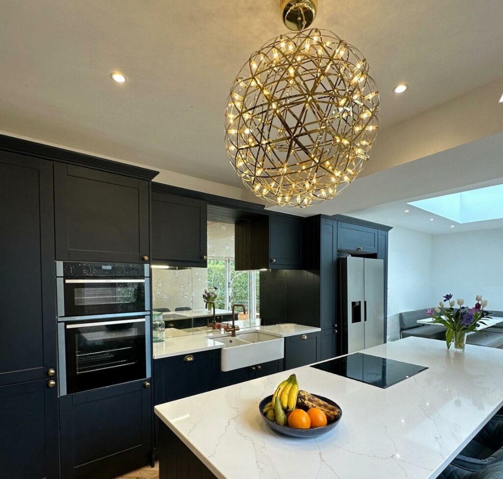 A new top of the range kitchen with a standard silver antique mirror splashback behind the sink